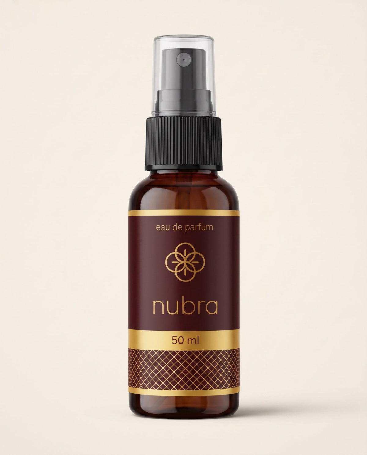 Nubra parfum 50 ml, etichetă bordo, flacon chihlimbariu pe fundal crem
