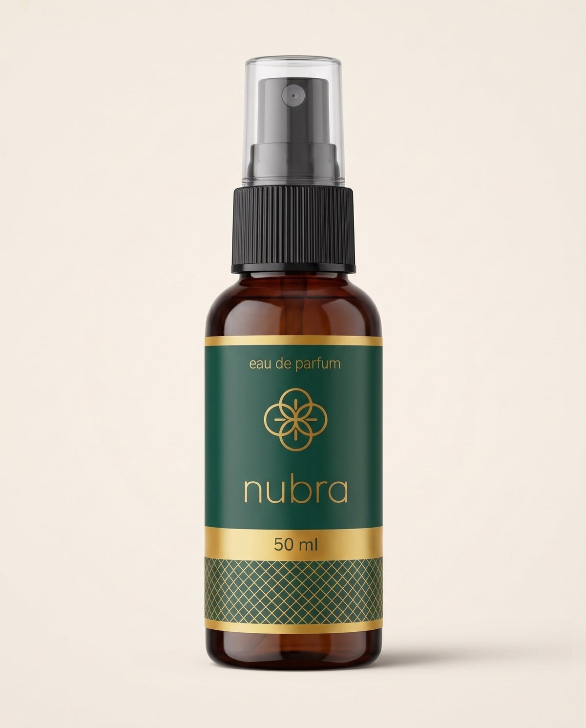 Nubra parfum 50 ml, etichetă verde, flacon chihlimbariu pe fundal crem